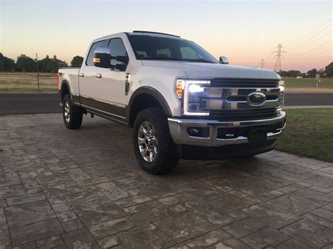 F250 leveled on 35s stock wheels - General F150 Discussion - 33s on Stock Height - Hey guys, Looking to buy a new set of tires for my 2020 F150 Sport 4xe with 18 wheels and was looking to get 275/70/18 as opposed to ny current OEM 275/65/18. Looks like a 1.1 difference in height. I am trying to get them on without rubbing or trimming.